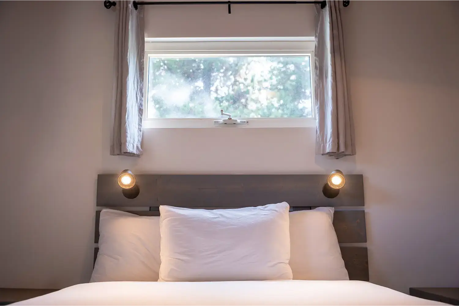 Close-up of a comfortable bed inside a Manning Park Resort Standard Cabin.