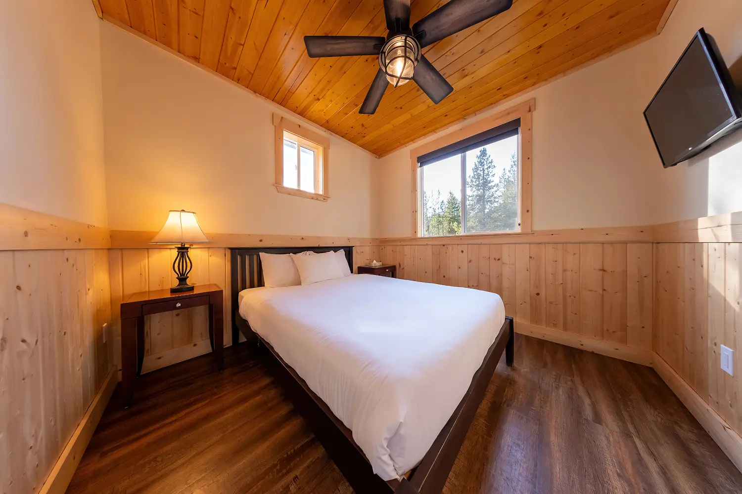 Master bedroom in a Manning Park Resort Premium Cabin, showcasing comfort and mountain retreat style.