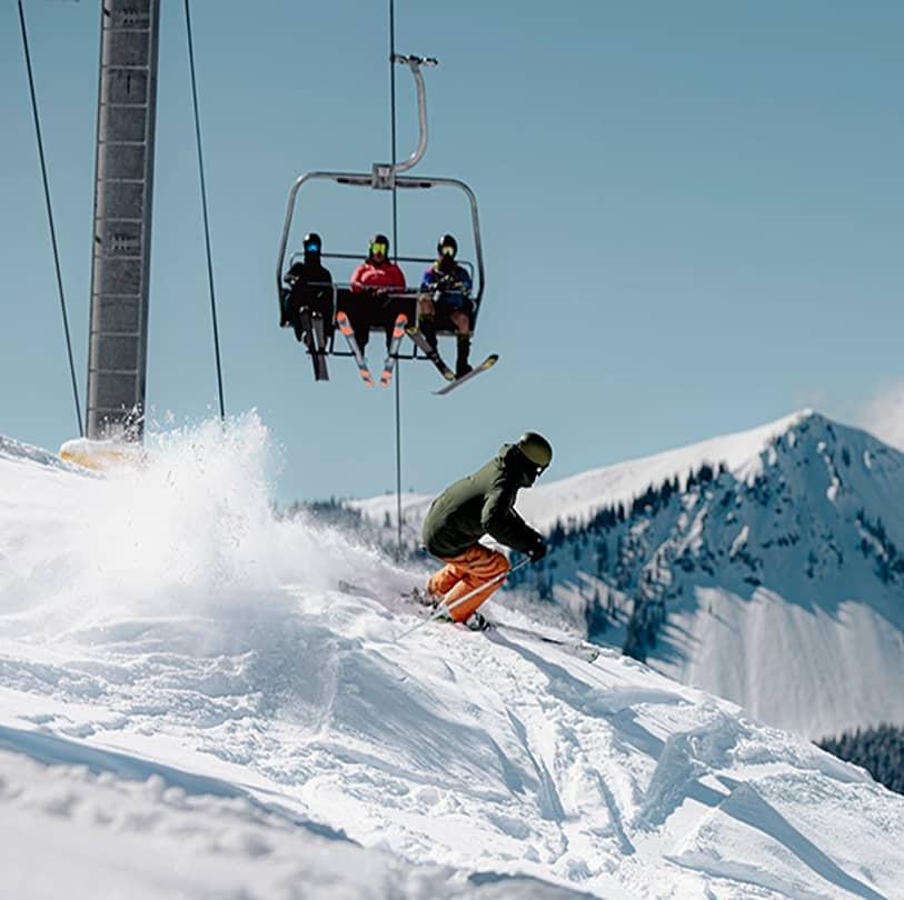 People skiing down snow-covered slopes at Manning Park Resort.