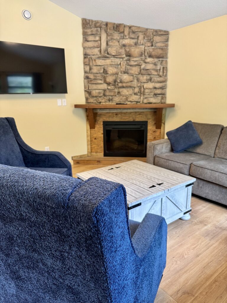 Deluxe cabin living room at Manning Park Resort with TV and comfortable seating.