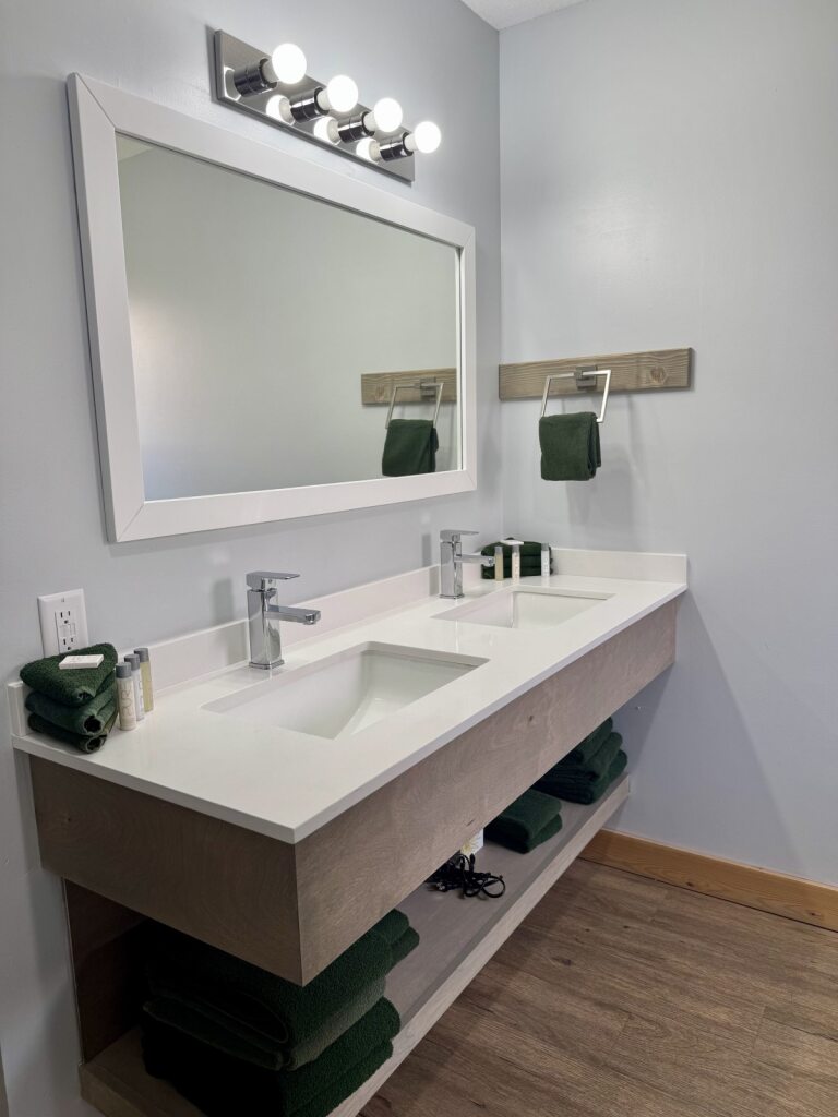 Bathroom inside a Deluxe Cabin, featuring modern amenities and rustic charm.