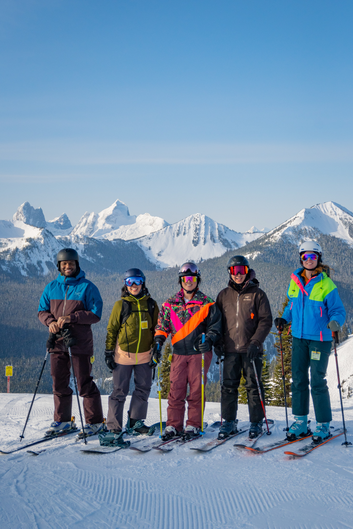 Group of friends smiling while skiing at Manning Park Resort.