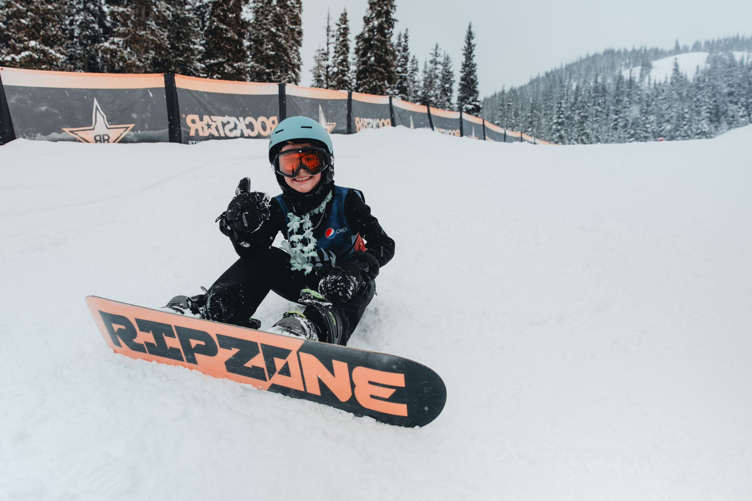 Child snowboarding in the terrain park at the Alpine, at Manning Park Resort.